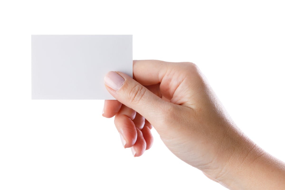 Woman's hand holding a business card