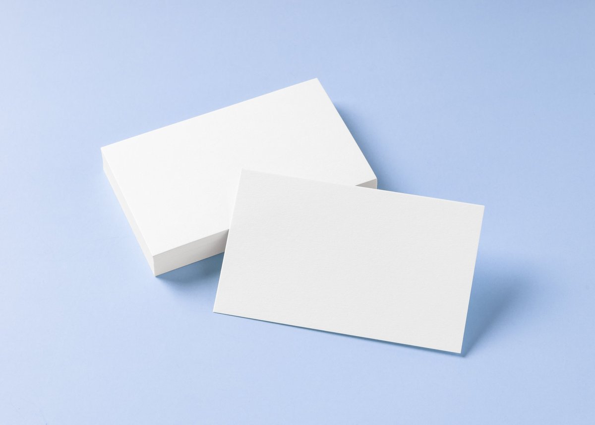 Blank white business card mockup on light blue background